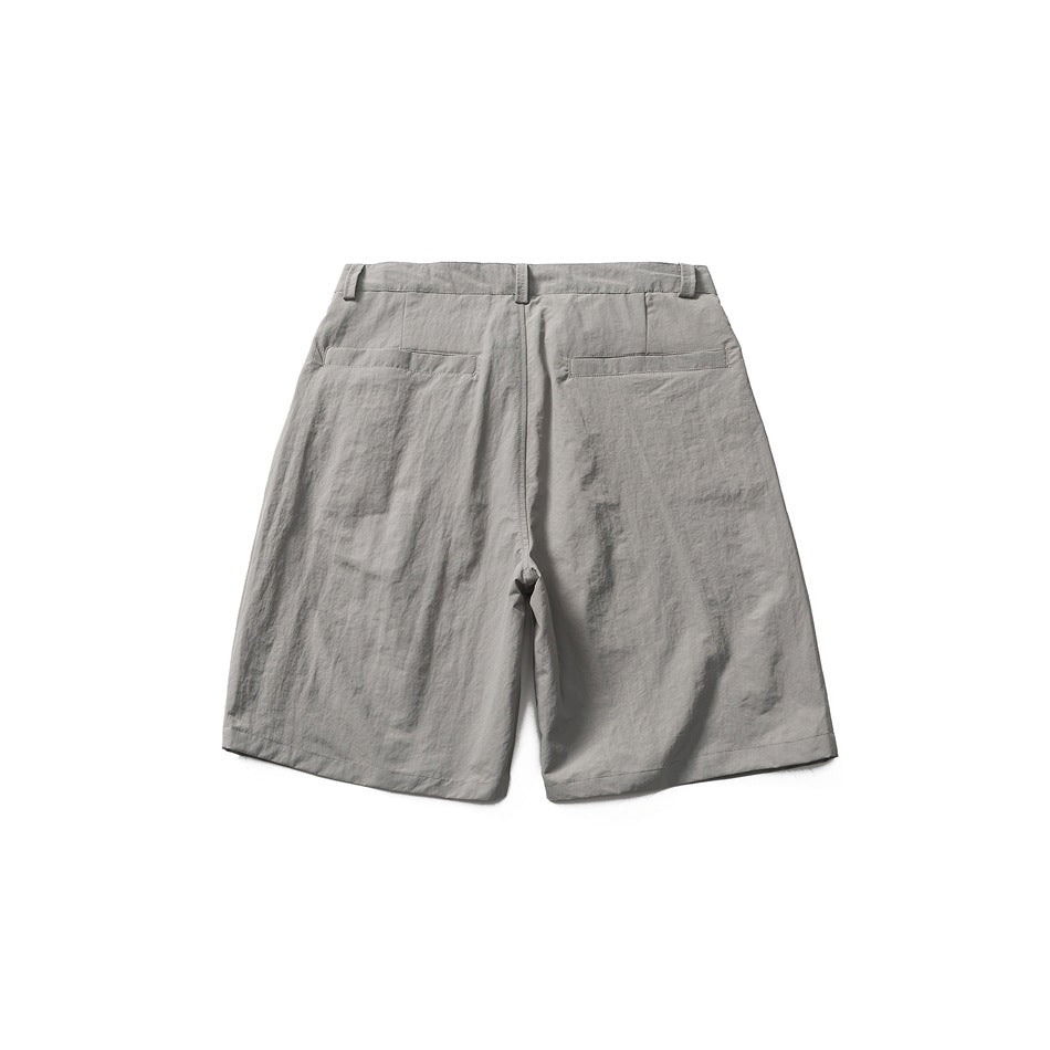 Back view of gray knee-length shorts showing two welt back pockets, belt loops and a crinkled fabric texture