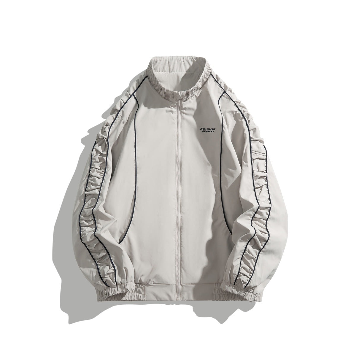 Light gray-beige stand-collar zip jacket with ruched raglan sleeves and navy piping, front view on white background