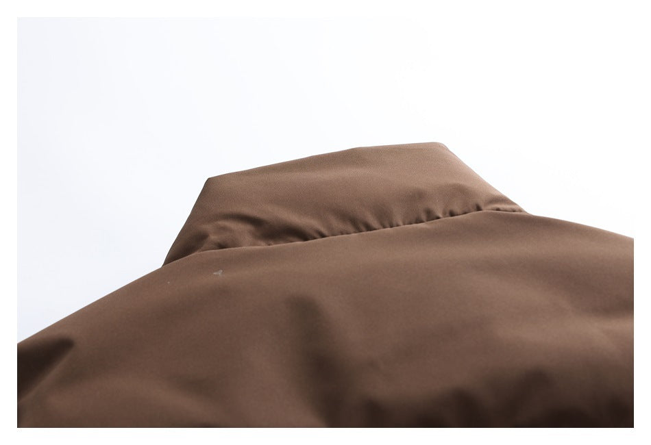 Close-up of the dark brown collar and smooth padded fabric of a jacket.