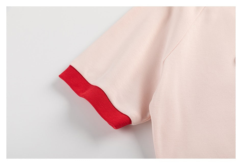 Pale pink sleeve ending in a bright red ribbed cuff.