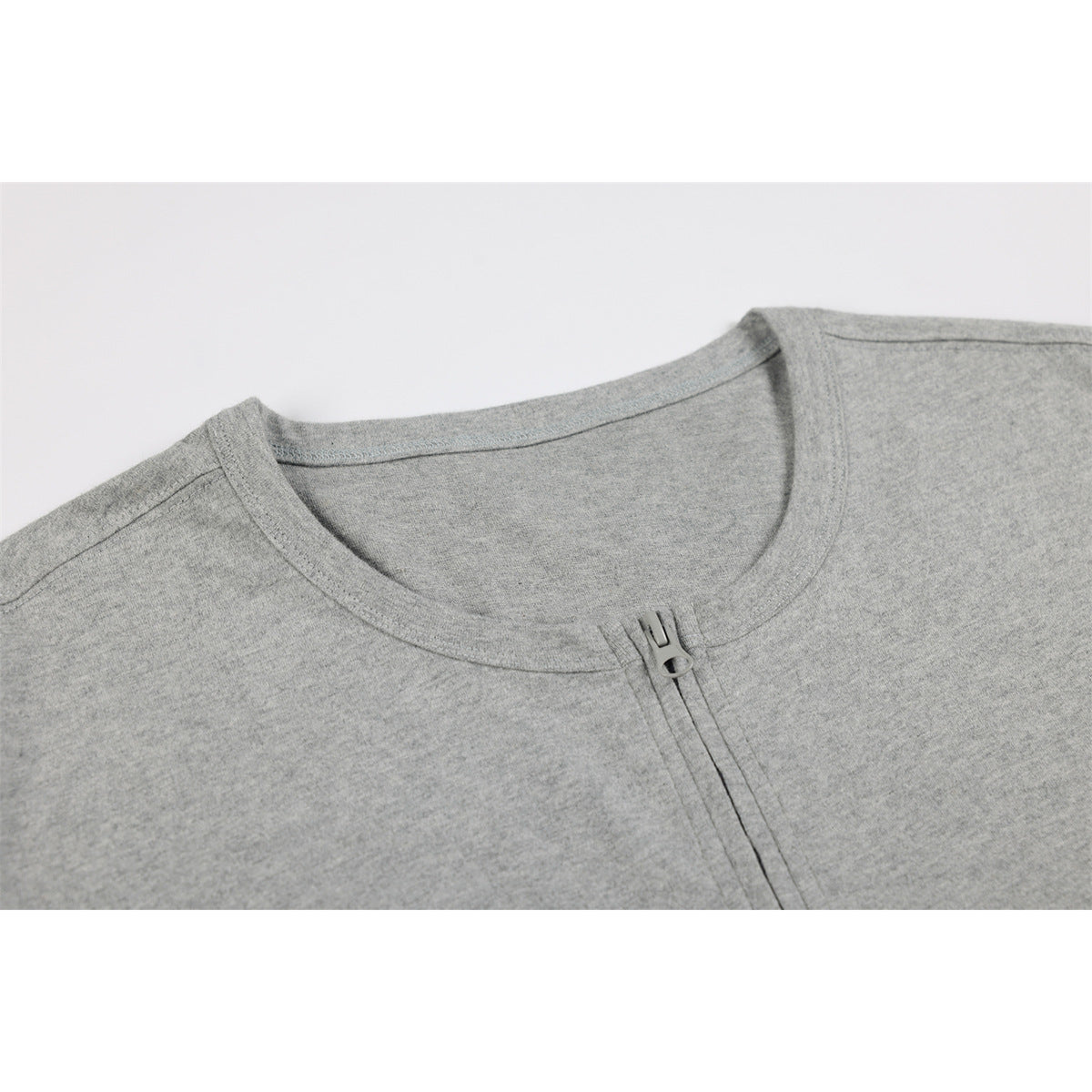 Close-up of a heather gray shirt's crew neckline and short front zipper.