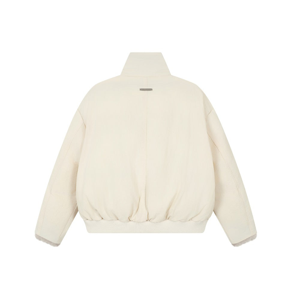Back view of an ivory oversized jacket with a high collar, long sleeves, ribbed hem, and light fur at the cuffs.
