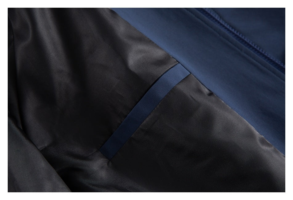 Close-up of the jacket interior showing dark lining, a navy seam strip, and zipper edge.
