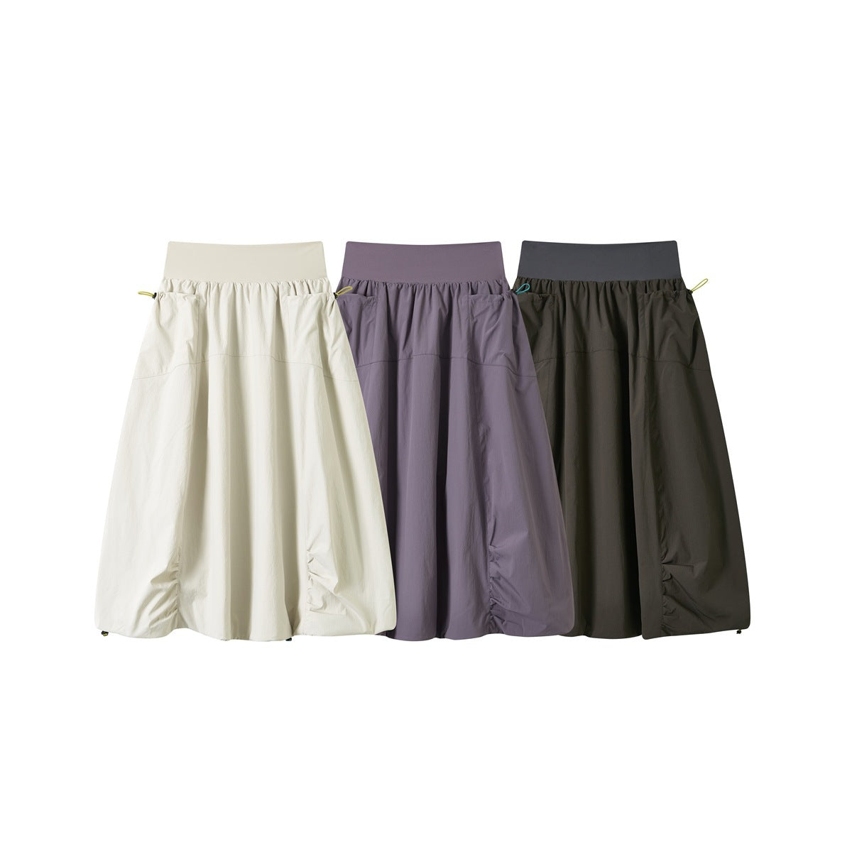 Three full-length gathered skirts shown flat in ivory, muted lavender, and dark charcoal.