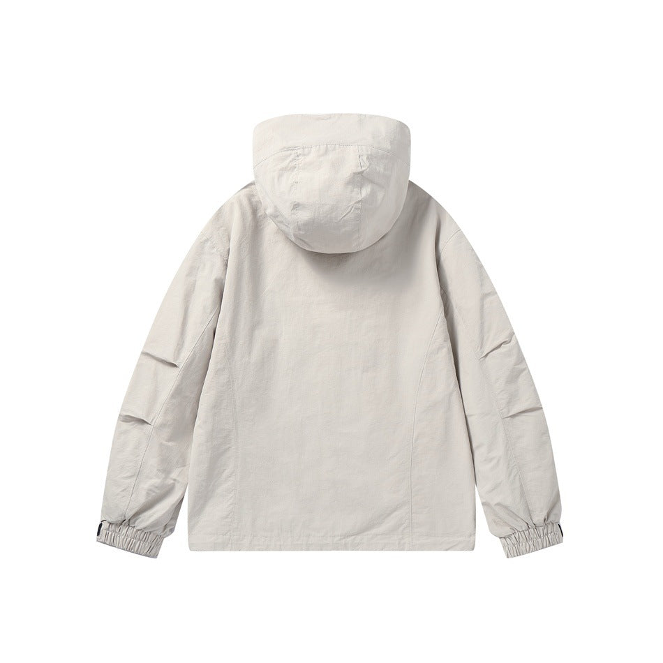 Beige hooded jacket back view with curved seams and elastic cuffs, flat lay