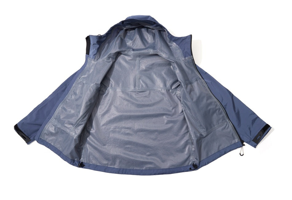Blue hooded jacket laid open to show its gray inner lining, seams, and front zipper.