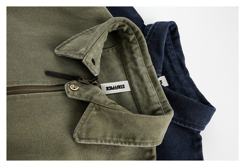 Close-up of olive and navy jacket collars and front zippers, with fabric texture and interior labels visible.