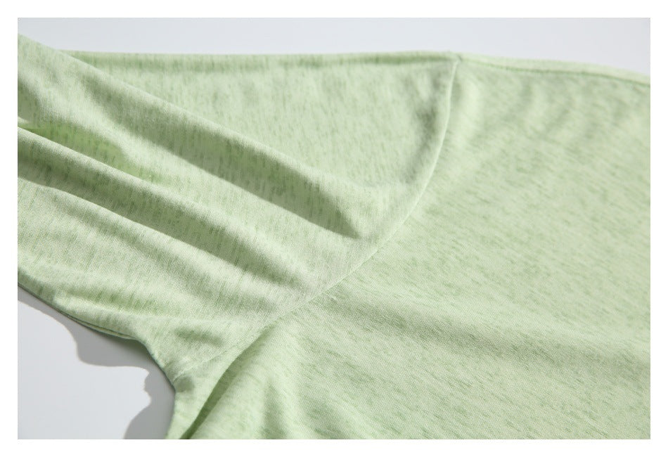 Close-up of the pale green shirt's sleeve and underarm seam.