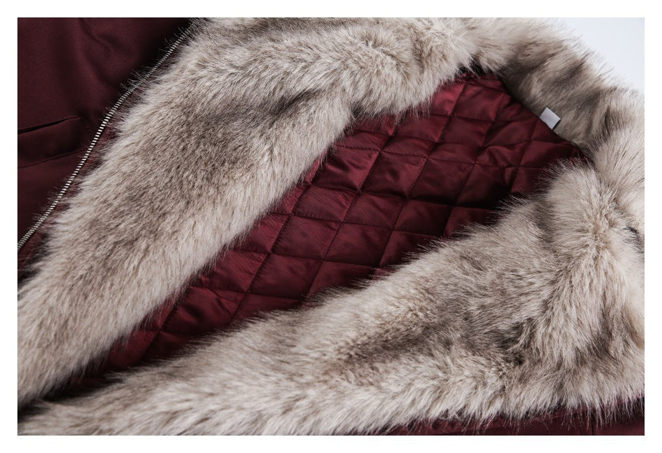 Close-up of a burgundy jacket's pale fur-trimmed hood and diamond-quilted lining.