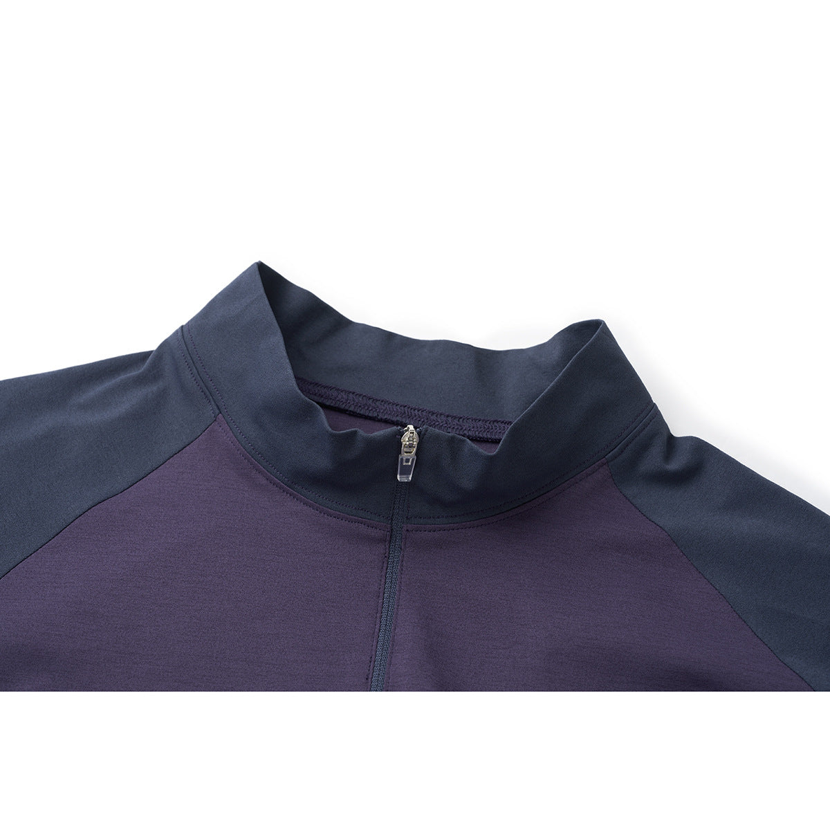 Close-up of a dark navy stand collar and zipper on a purple and navy long-sleeve top.