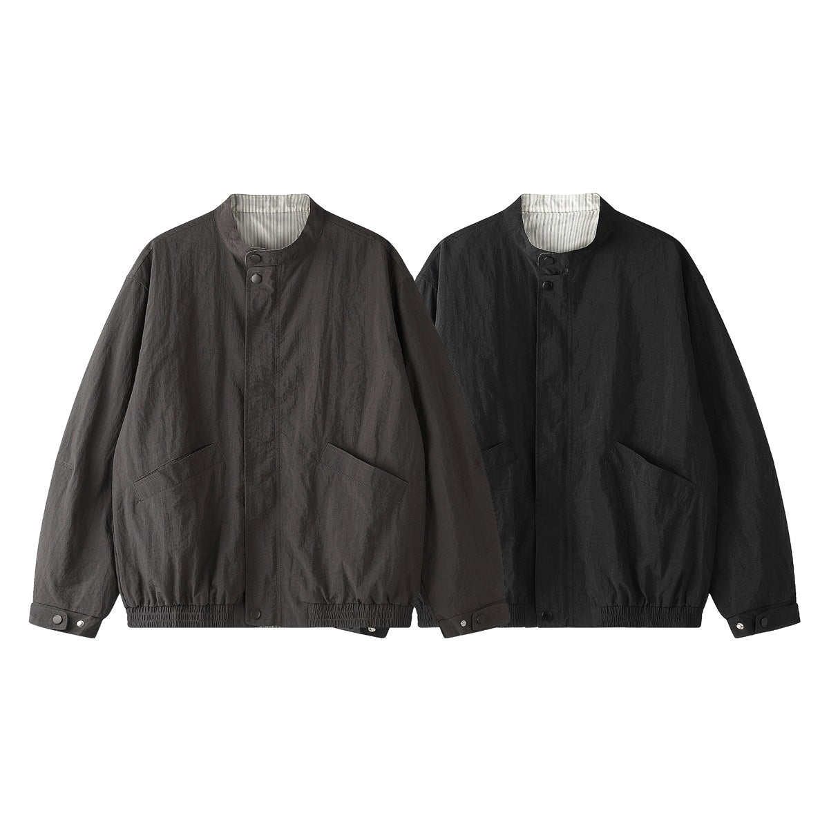 Two front-facing stand-collar jackets in charcoal gray and black, each with snap closures and slanted pockets.