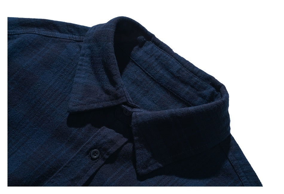 Close-up of a dark navy shirt collar and button placket.
