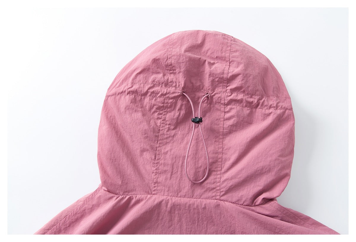 Close-up of a pink hood with stitched panels and an adjustable drawcord with a black toggle.
