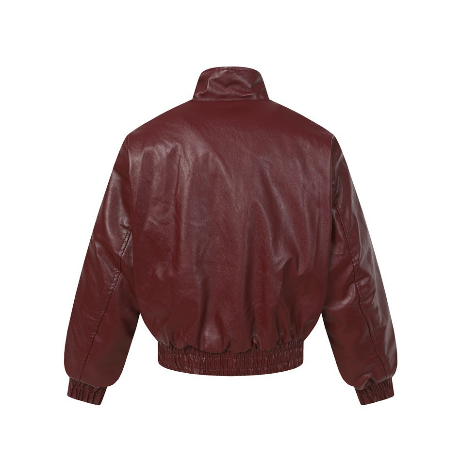 Back view of a burgundy jacket with a stand collar, long sleeves, gathered cuffs, and an elasticized hem.
