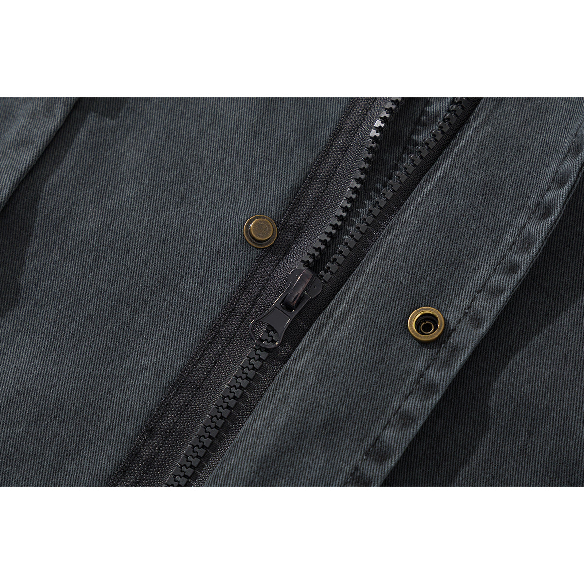 Close-up of the charcoal jacket's black zipper and brass snap fasteners.