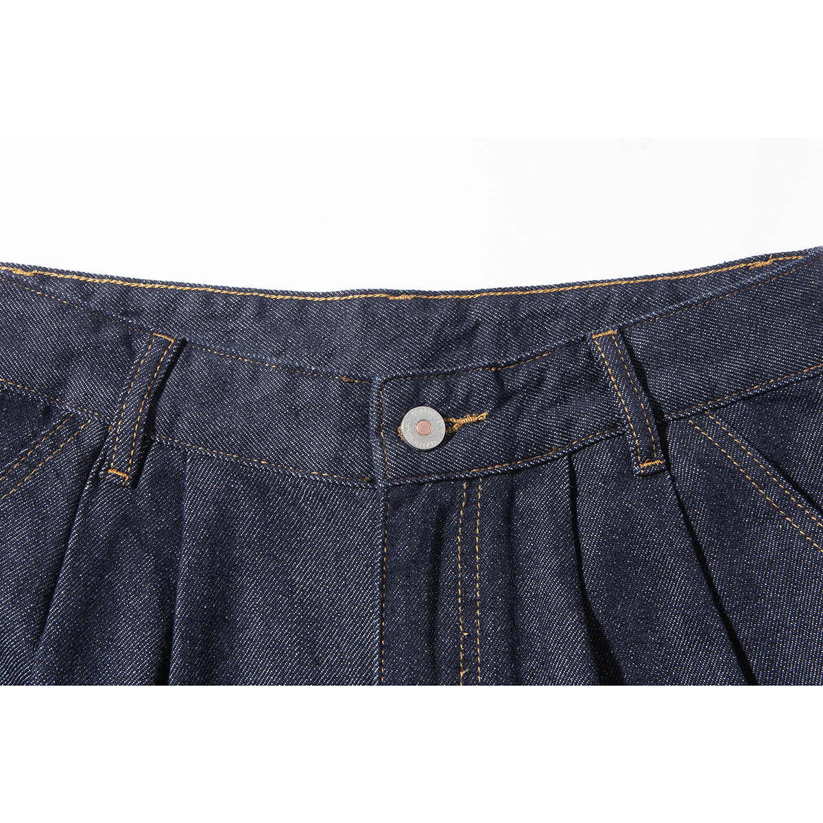 Close-up of dark indigo denim shorts showing the waistband, button, belt loops, pleats, and gold-colored stitching.