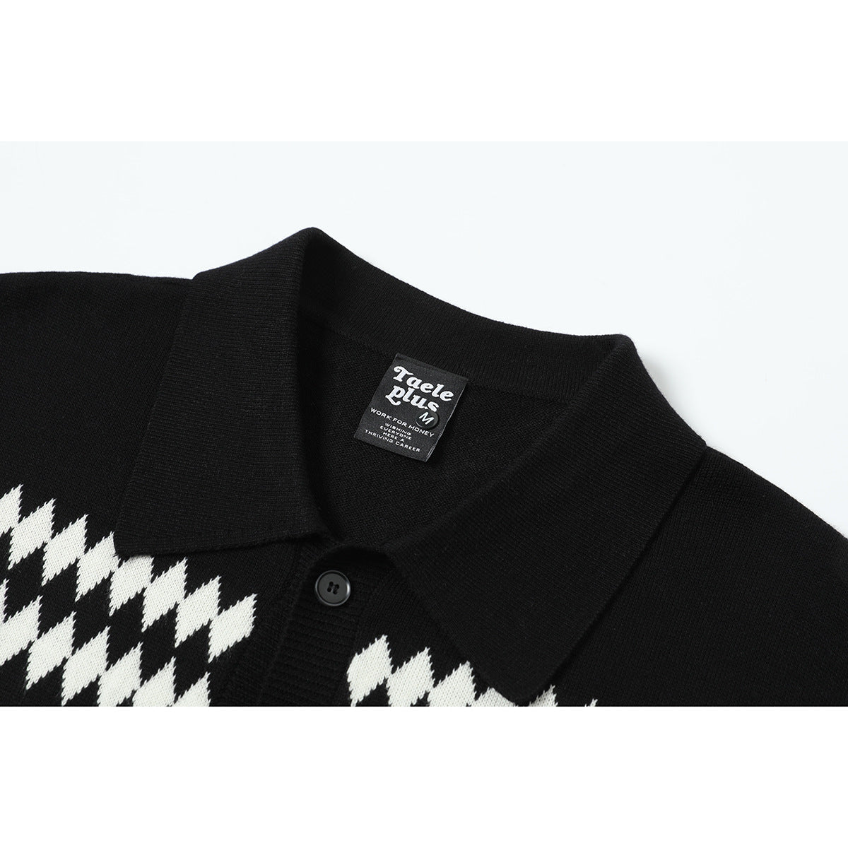 Close-up of a black knit shirt collar, button, and white geometric pattern with a sewn-in neck label.