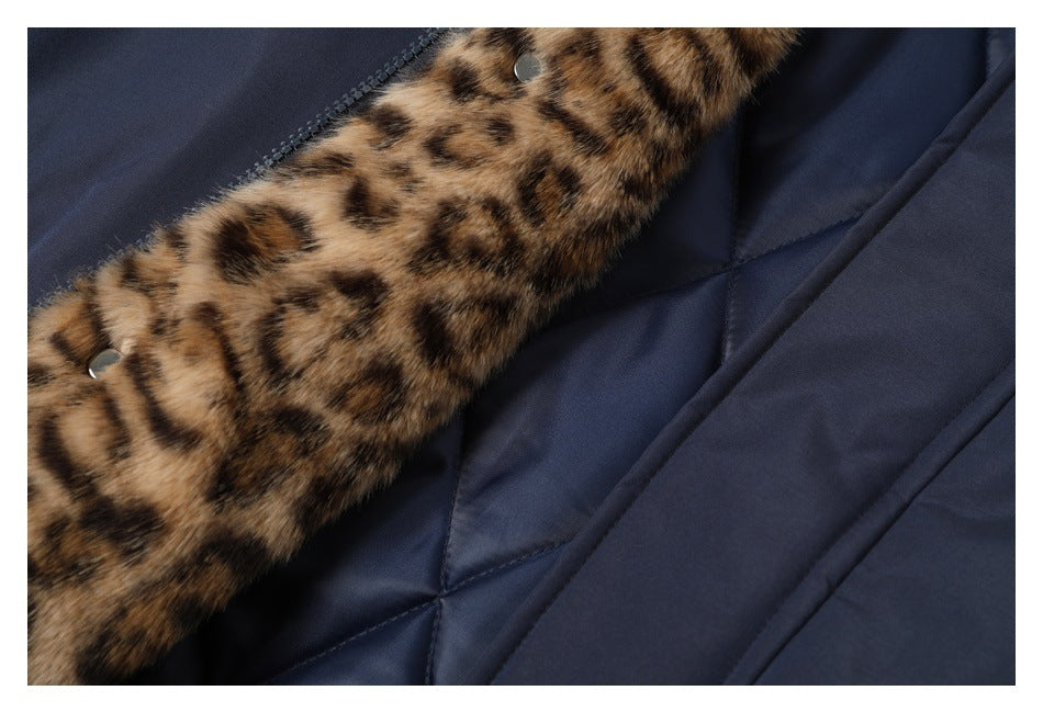 Close-up of a dark navy quilted garment with brown and black spotted fur trim and metal snaps.