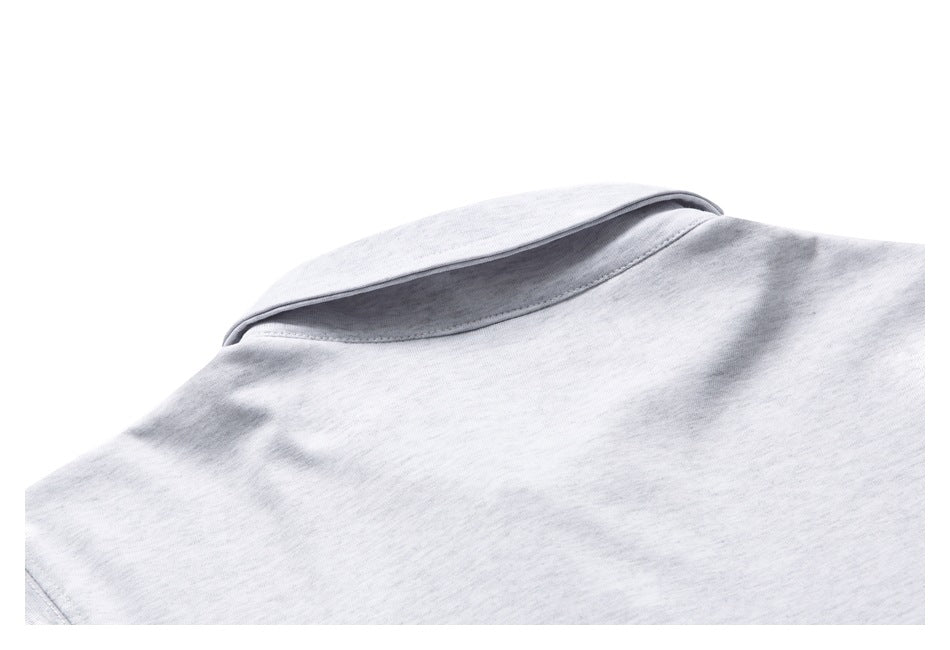 Close-up of a folded collar on a light gray knit garment.