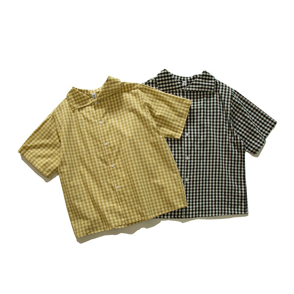 Two short-sleeve button-up shirts laid together: one mustard-and-cream check and one black-and-cream check.