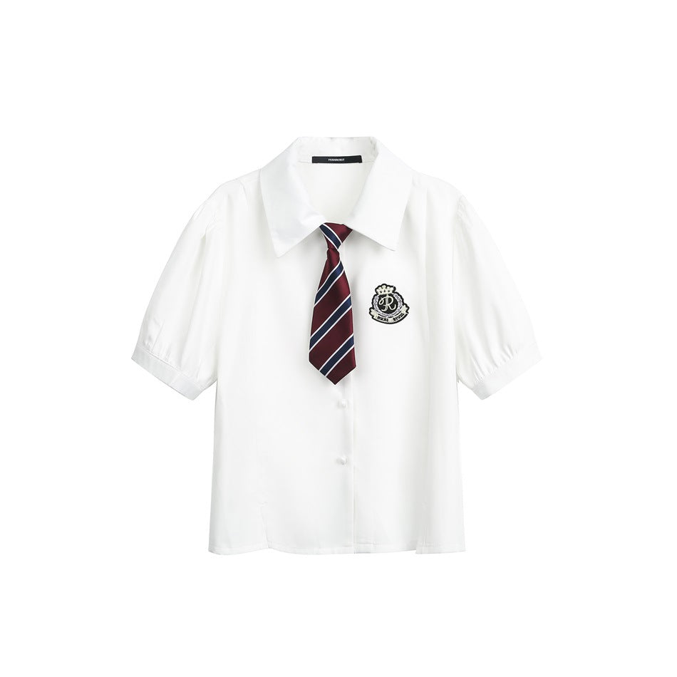 White short-sleeve button-front shirt with pointed collar, puff sleeves, crest patch and burgundy striped tie