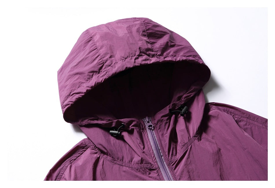 Close-up of a plum jacket's hood, adjustable drawcords, and front zipper.