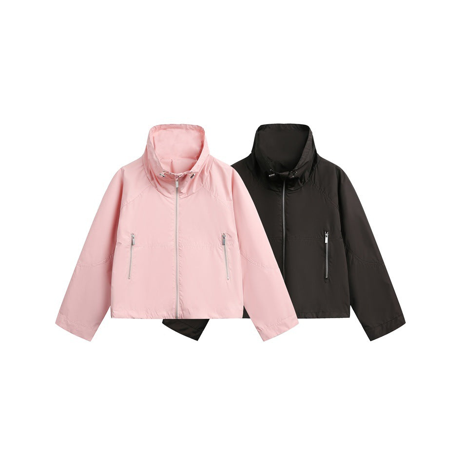 Two cropped zip jackets shown together: one light pink and one black, both with high collars and zip pockets.