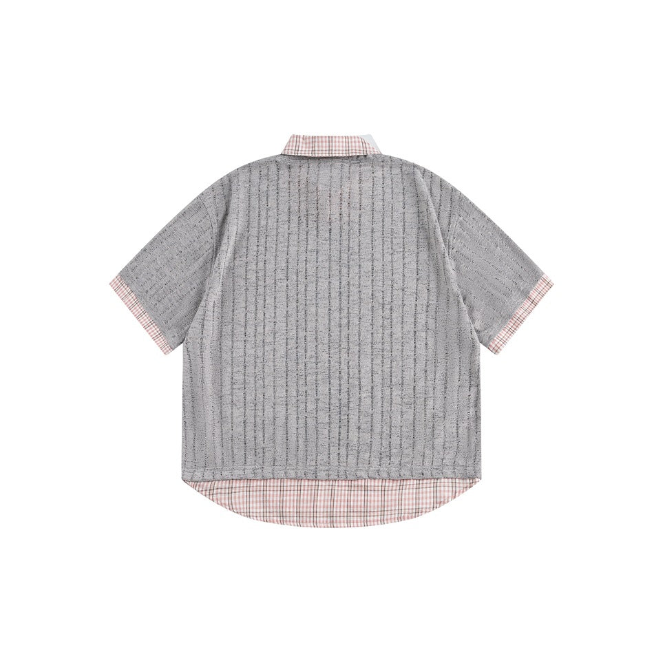 Back view of a gray short-sleeve shirt with subtle vertical texture and pink checked collar, cuffs, and longer hem.