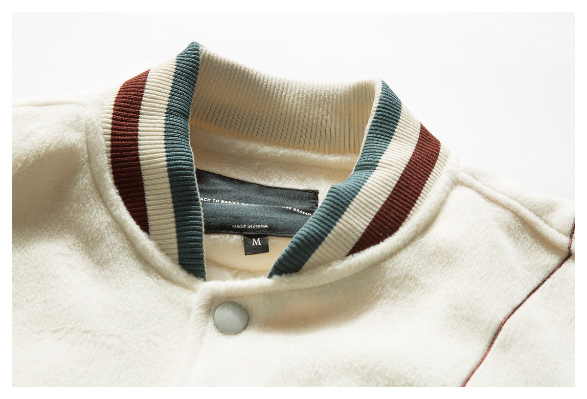 Close-up of a cream jacket's striped ribbed collar, snap closure, and inner label.