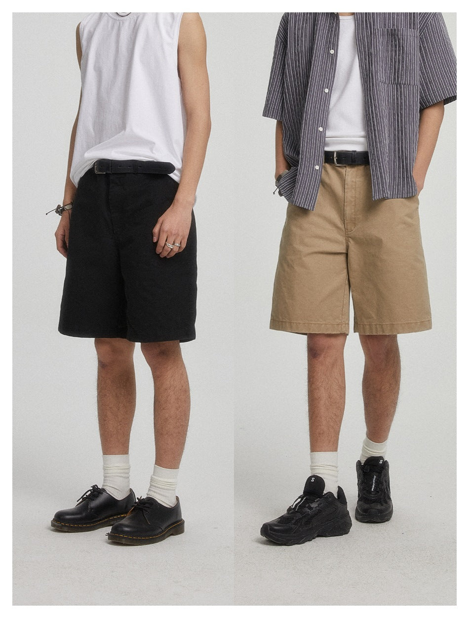 Two models wearing black and khaki wide-leg shorts with belts, white socks and sneakers, cropped at the torso