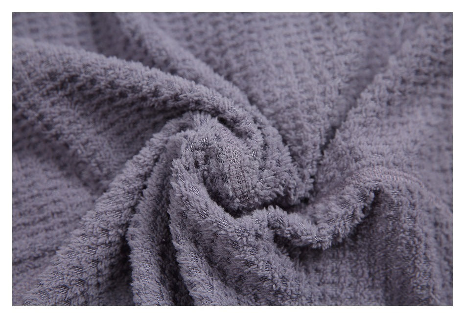 Macro view of the gray garment's soft-looking, raised textured surface.