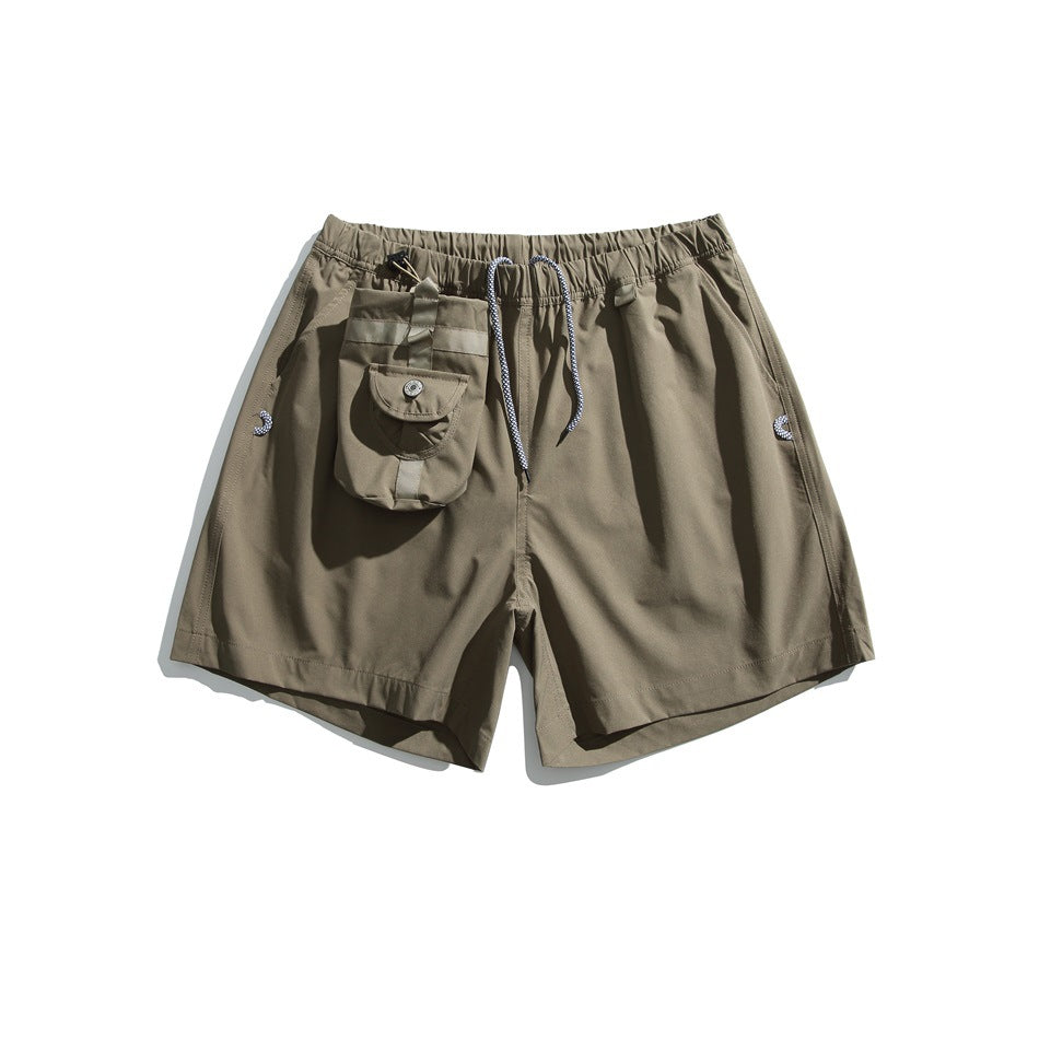 Olive drawstring shorts with an elastic waist, side pockets, and an attached flap pouch.