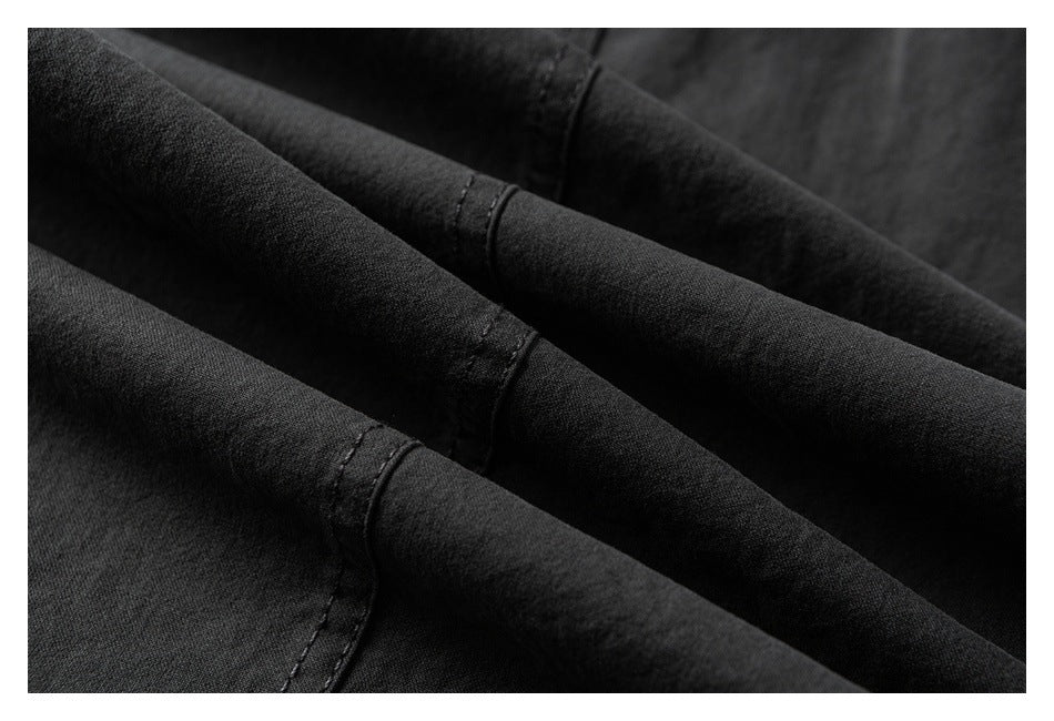 Close-up of dark fabric folds and finished stitched seams.