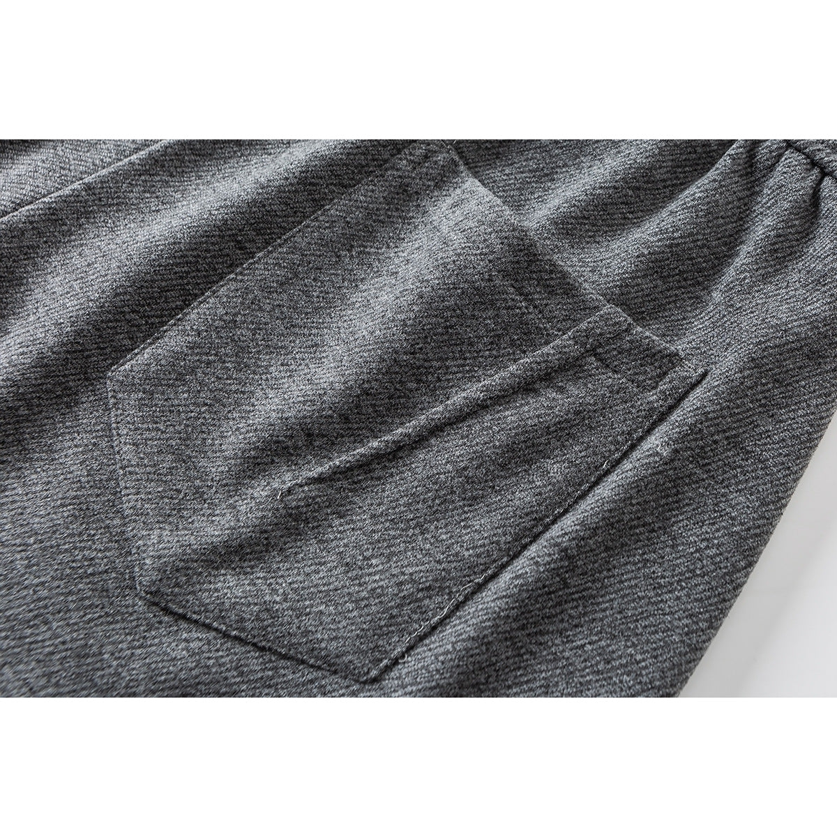 Close-up of a large patch pocket on gray wide-leg pants.