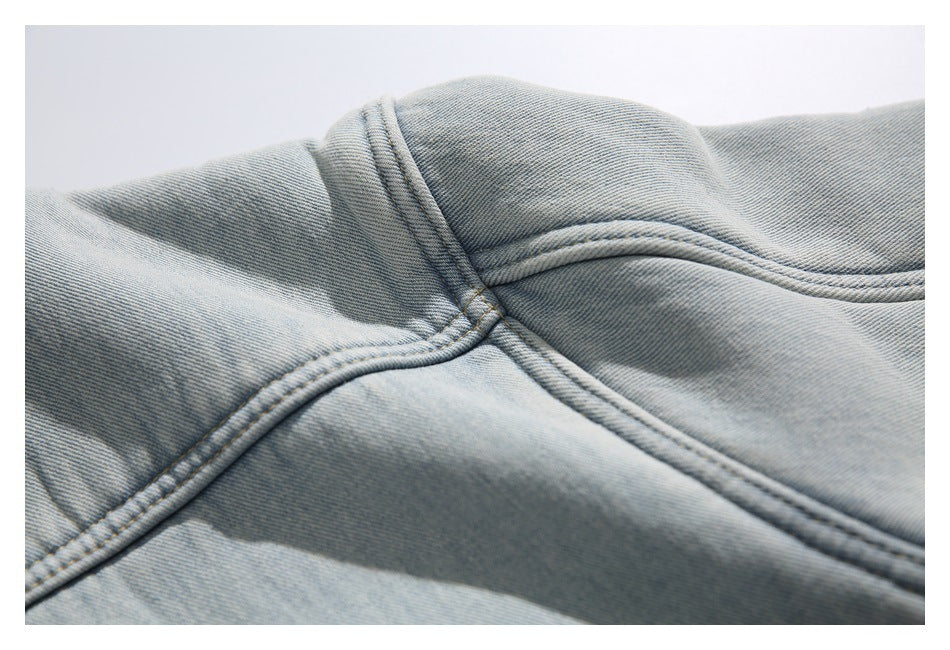 Close-up of double-stitched seams on light blue denim.