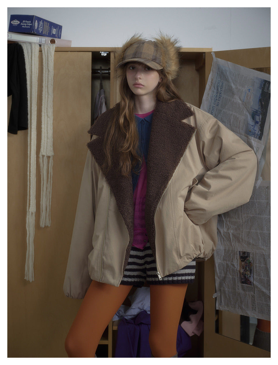 Front view of a model wearing an oversized beige jacket with a wide dark brown fleece collar and zip front.