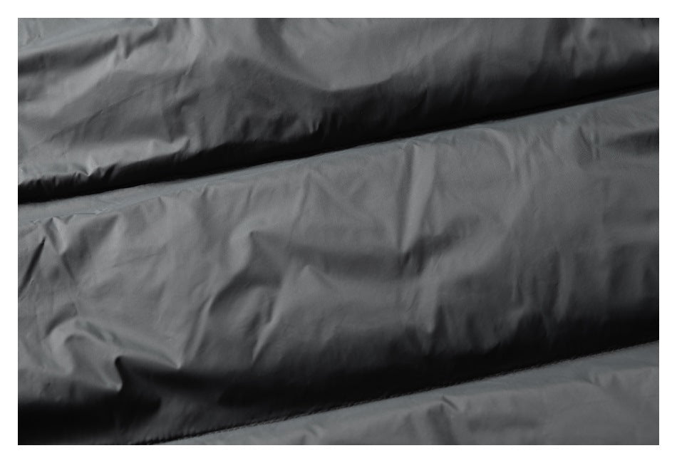 Close-up of horizontal padded sections on a black garment.