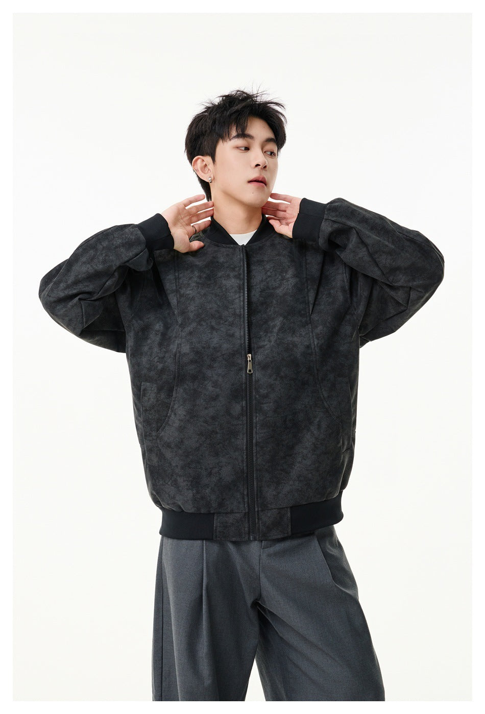 Model wearing a dark charcoal mottled zip-front jacket with a ribbed collar, cuffs and hem.