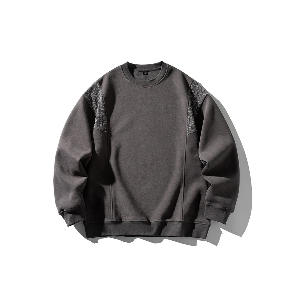 Dark gray crew-neck sweatshirt flat lay with textured gray shoulder panels and ribbed cuffs and hem