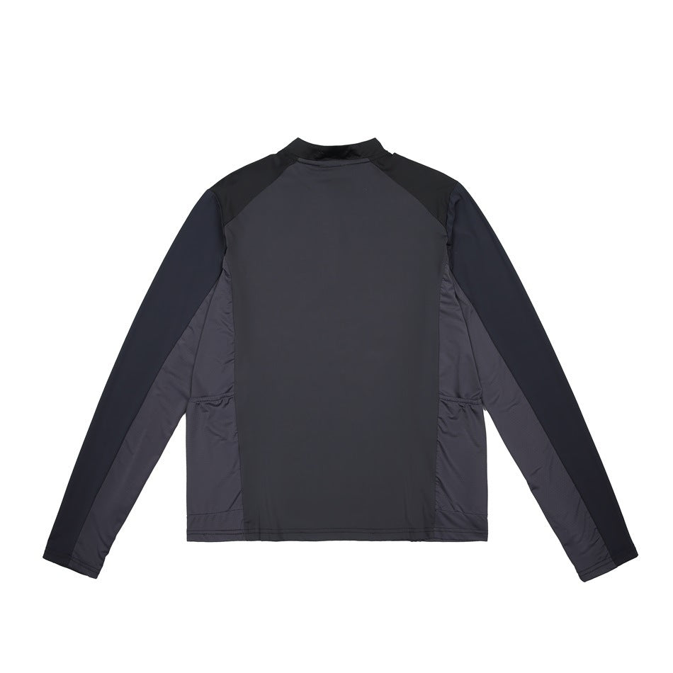Back view of a dark charcoal long-sleeve top with black shoulder panels and side inserts.