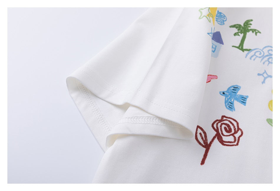 Close-up of the white T-shirt's short sleeve hem and stitching, with part of the colorful print visible.