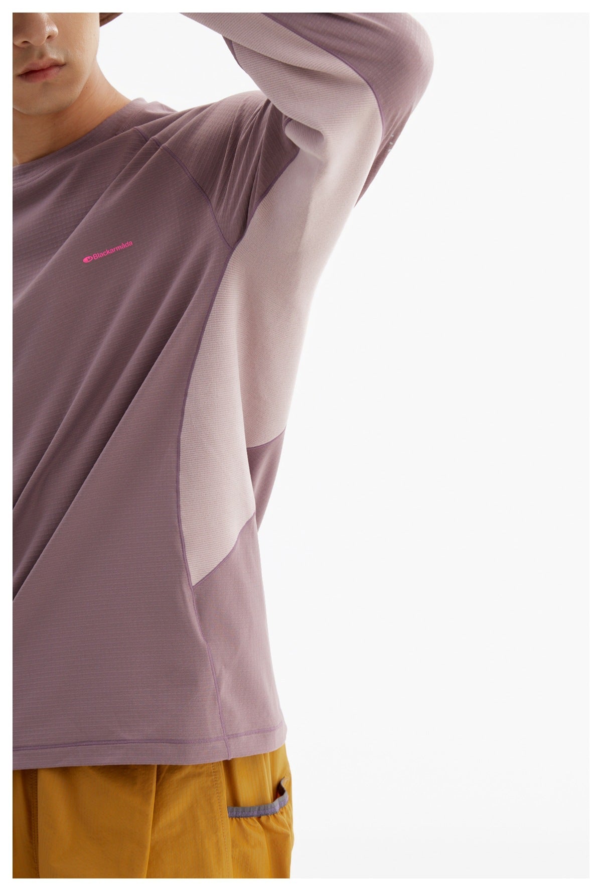Close-up of the mauve shirt showing its pale contrasting underarm and side panels with seam details.