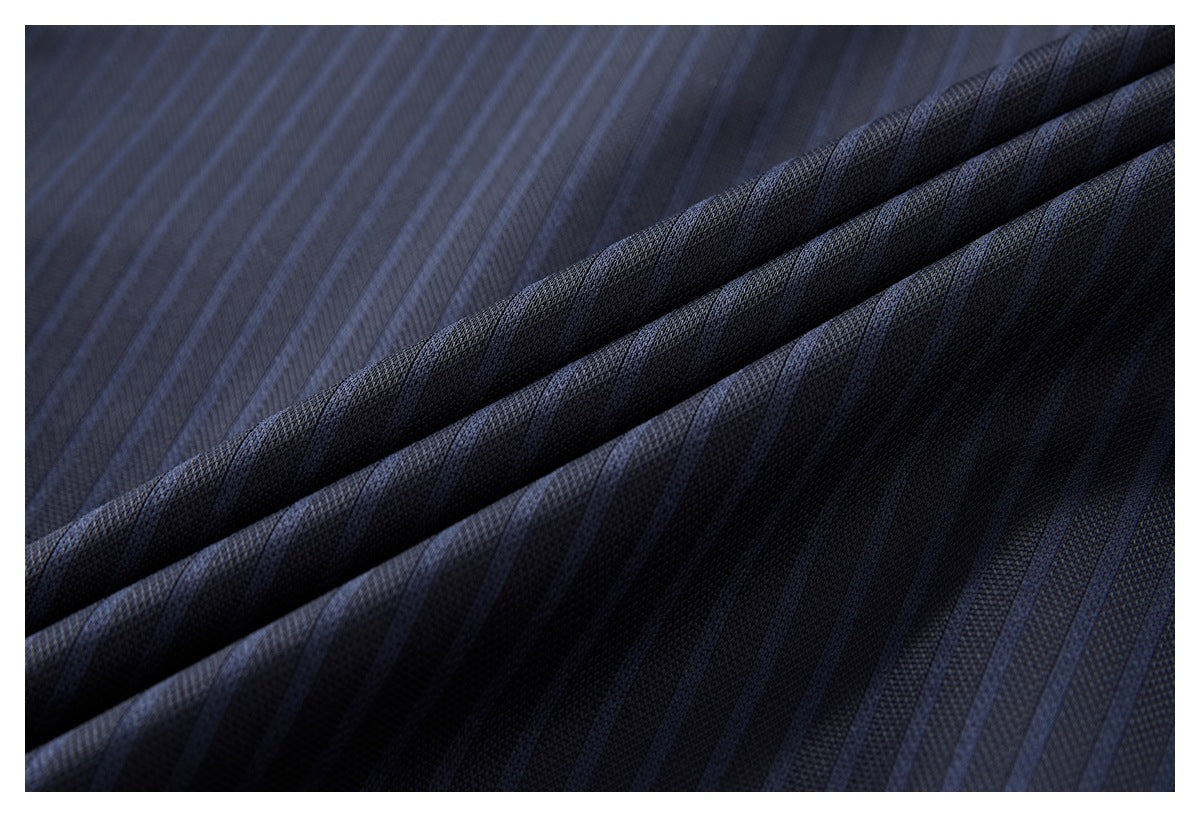 Macro view of dark navy pinstriped shirt fabric folded to show its textured surface.