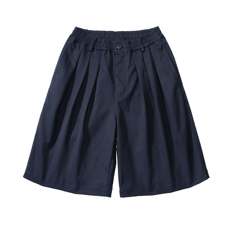 Navy wide-leg knee-length shorts with pleats, elastic waistband and front button, flat lay front view