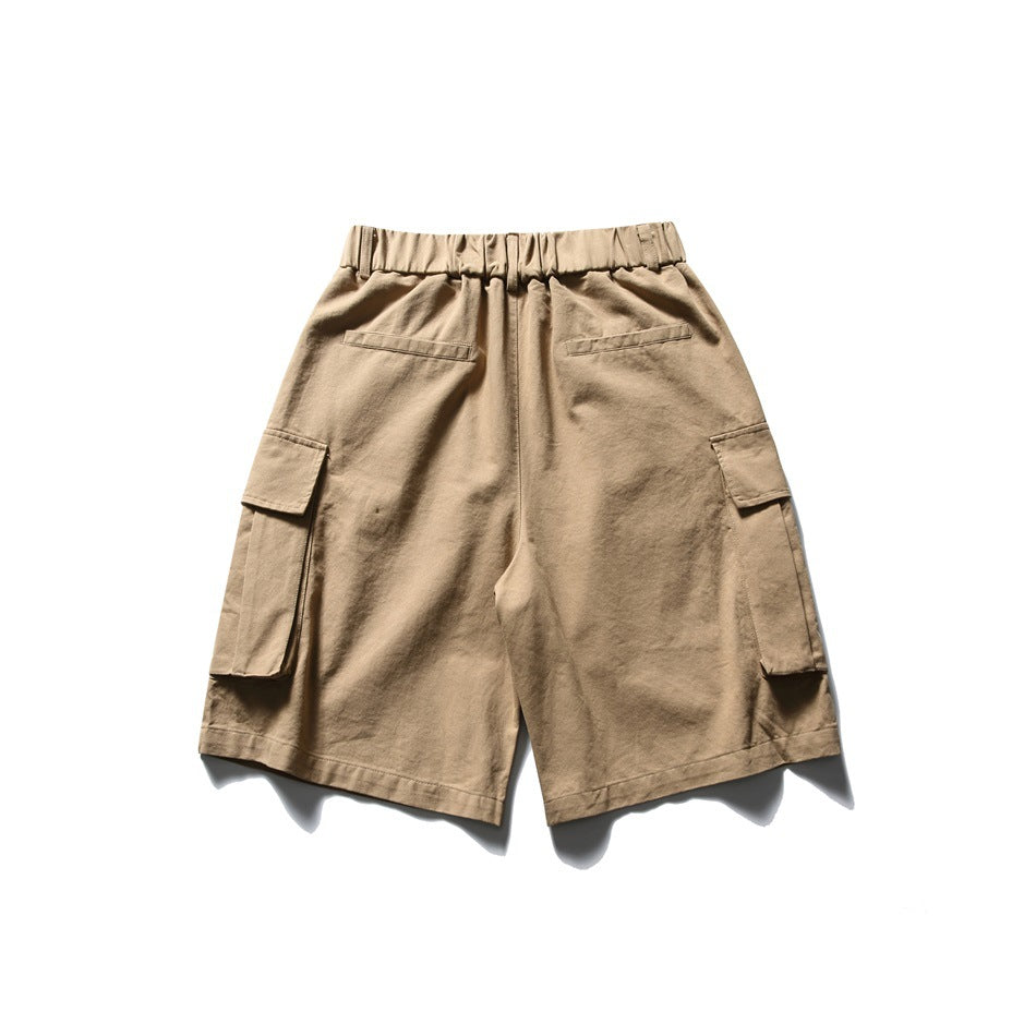 Back view of tan cargo shorts with an elastic waistband, two welt pockets, and large flap pockets on the sides.