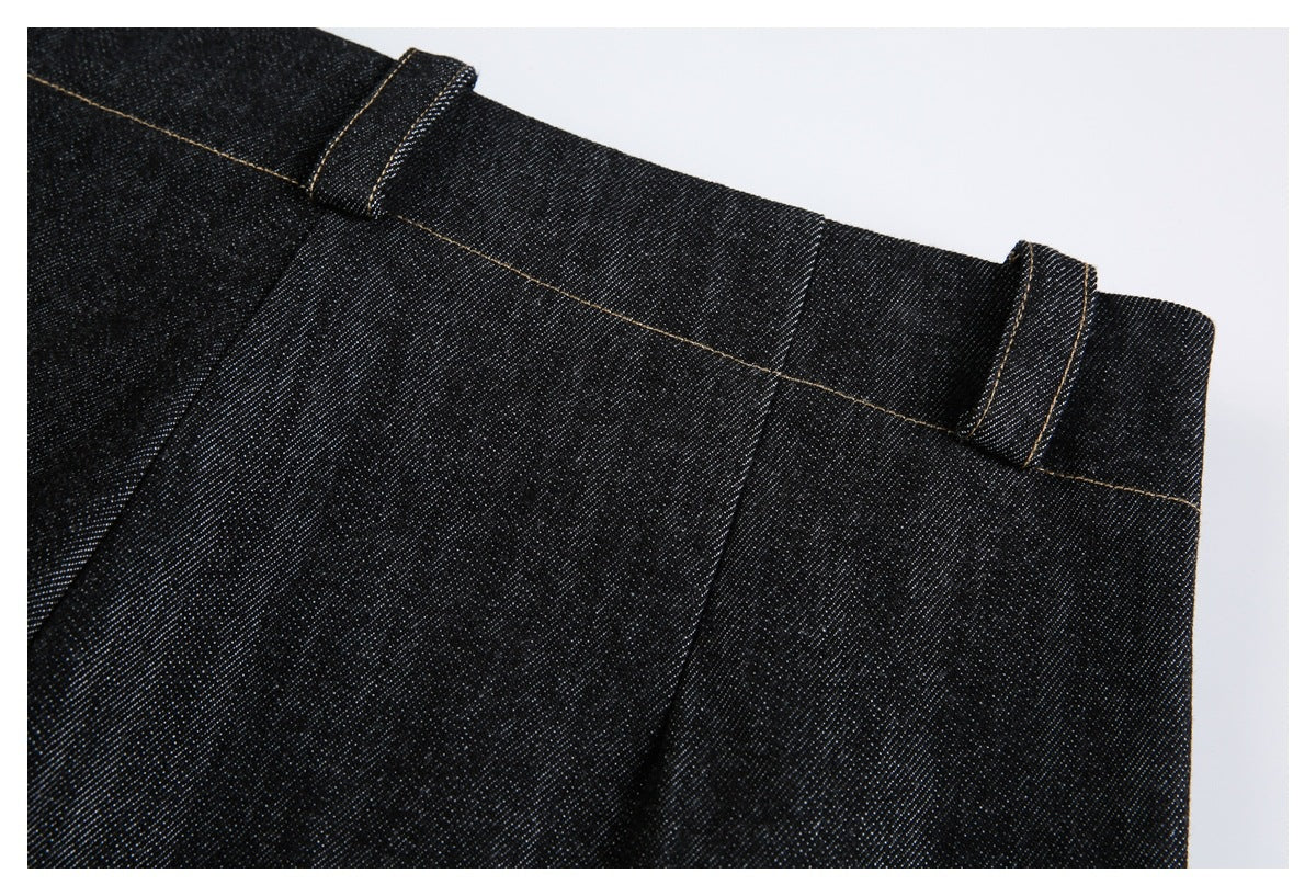 Close-up of the black jeans waistband with belt loops and tan stitching.