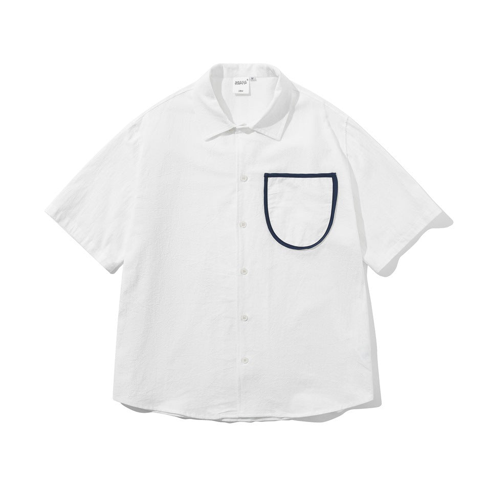 White short-sleeve button-up shirt with a large U-shaped chest pocket trimmed in navy piping, flat lay