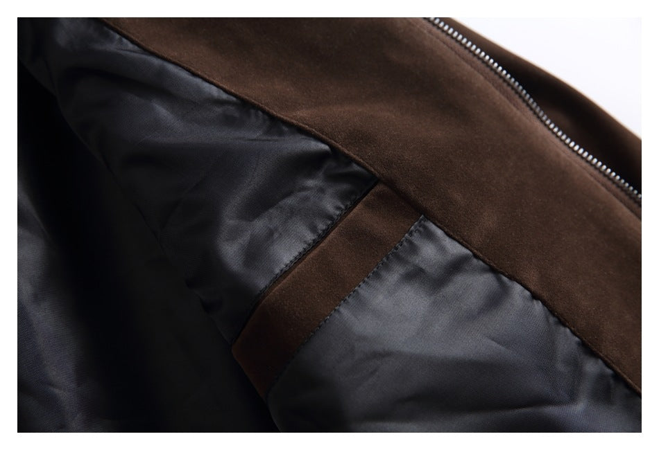 Inside view of a dark brown garment showing black lining, a zipper, and a stitched seam.