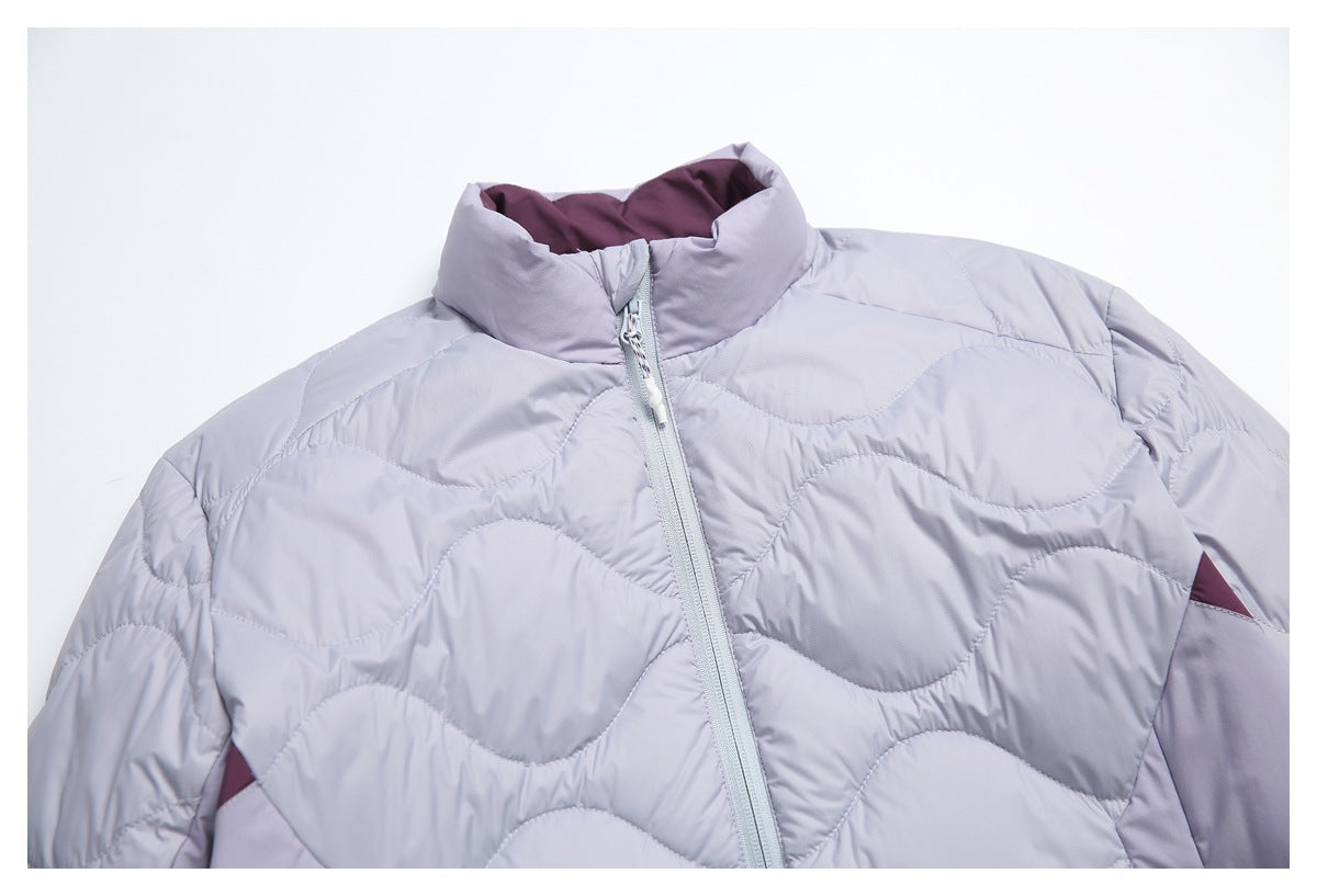 Upper front of a lavender quilted jacket, showing its high collar, zipper, and wavy stitching.