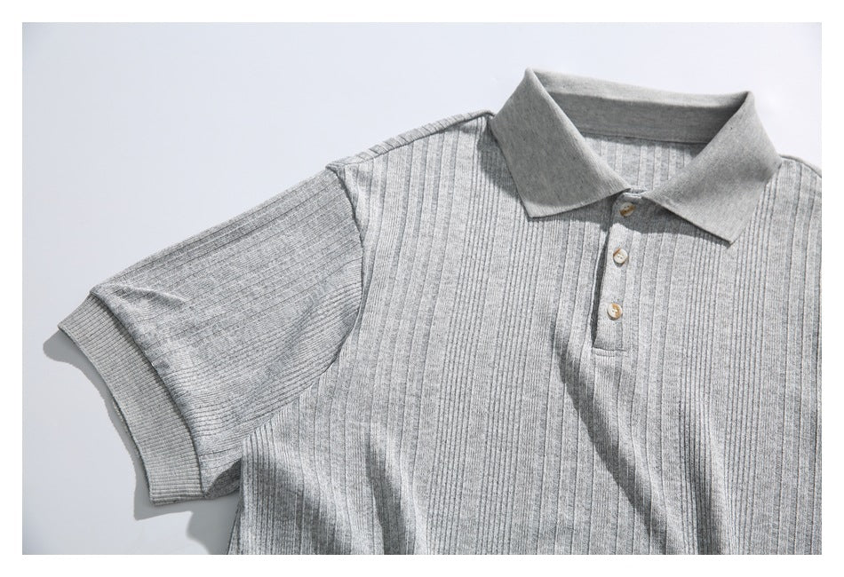 Flat-lay front view of a light gray ribbed short-sleeve polo shirt with a collar and three-button placket.